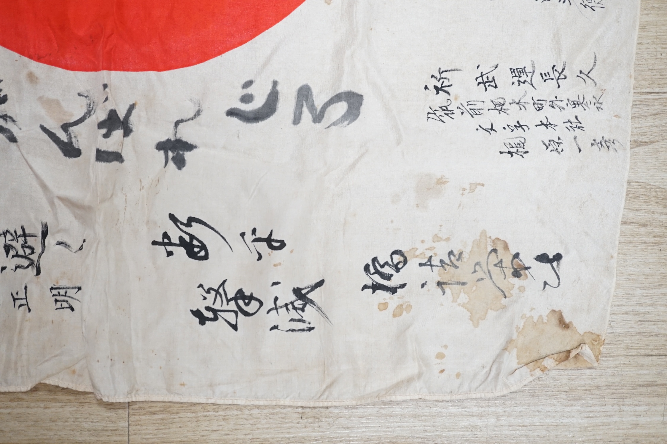 A WWII Japanese signed silk prayer flag, 83 x 73cm. Condition - fair, significant staining in some areas